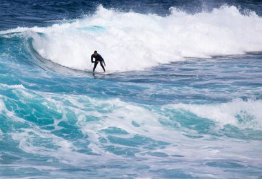 PUERTO DE SANTIAGO, TENERIFE - JUNE 2022: surfer riding the waves in Tenerife