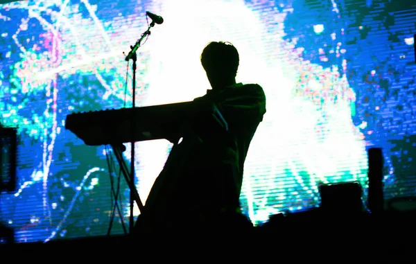 singer silhouette in stage lights live concert