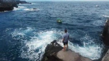 man watching waves of the sea