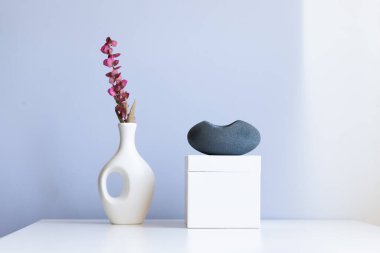cosmetic product mock up with white boxes and vase