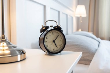 vintage alarm clock in bright bedroom