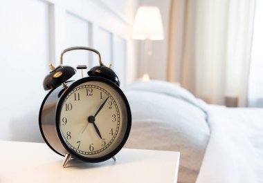 vintage alarm clock in bright bedroom