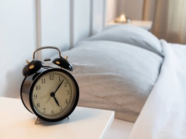 vintage alarm clock in bright bedroom