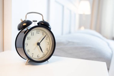 vintage alarm clock in bright bedroom