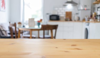 empty wooden tabletop and blurred kitchen mock up for product display