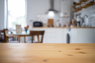 empty wooden tabletop and blurred kitchen mock up for product display