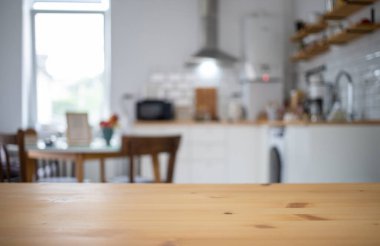 empty wooden tabletop and blurred kitchen mock up for product display