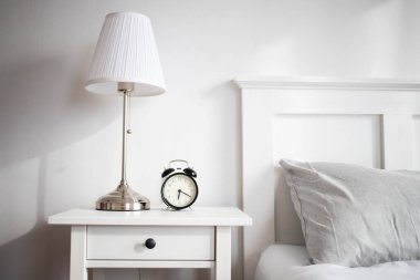 vintage alarm clock in bright bedroom