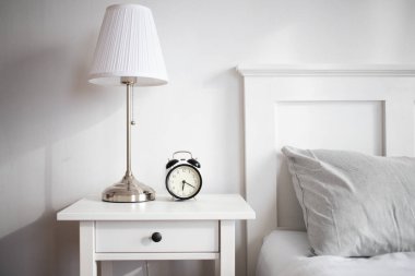 vintage alarm clock in bright bedroom