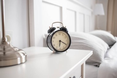 vintage alarm clock in bright bedroom