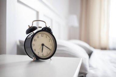 vintage alarm clock in bright bedroom