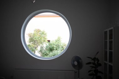 round window tree and house