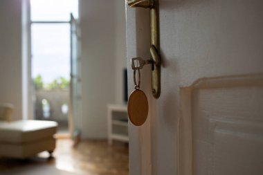 key opening white door to a modern home