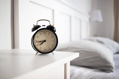 vintage alarm clock in bright bedroom