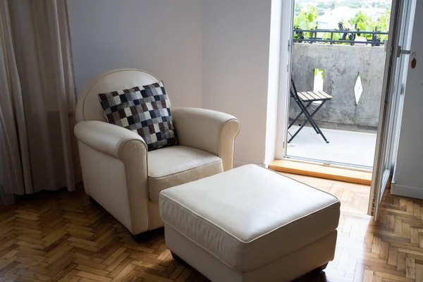 beige armchair in cozy living room