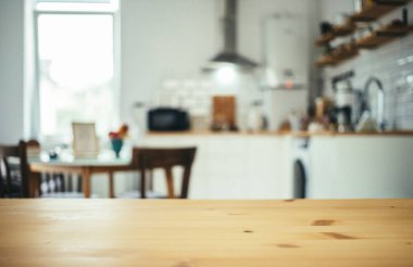 empty wooden tabletop and blurred kitchen mock up for product display