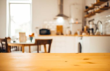 empty wooden tabletop and blurred kitchen mock up for product display