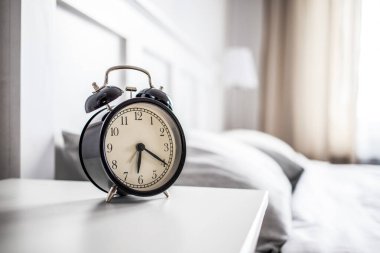 vintage alarm clock in bright bedroom