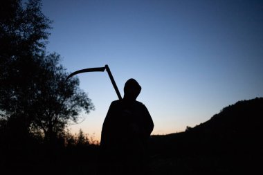 grim reaper, the death itself, scary horror shot of Grim Reaper holding scythe