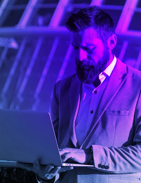 Handsome Businessman Laptop City Purple Neon Light — Zdjęcie stockowe