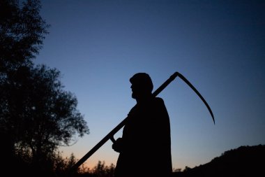 grim reaper, the death itself, scary horror shot of Grim Reaper holding scythe