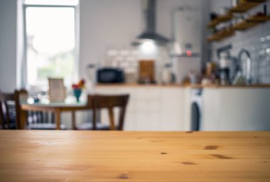 empty wooden tabletop and blurred kitchen mock up for product display