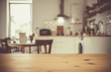 empty wooden tabletop and blurred kitchen mock up for product display