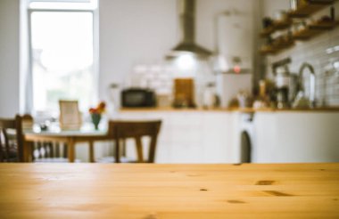 empty wooden tabletop and blurred kitchen mock up for product display