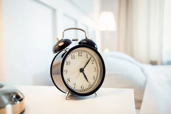 vintage alarm clock in bright bedroom