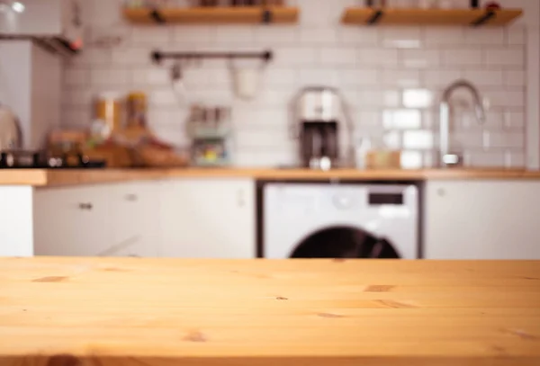 empty wooden tabletop and blurred kitchen mock up for product display