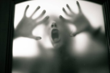 scary picture of hands behind glass, horror ghost woman behind door, Halloween  concept