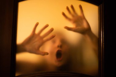 scary picture of hands behind glass, horror ghost woman behind door, Halloween  concept