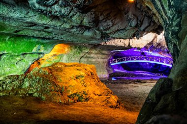 illuminated cave in Romania pestera bolii