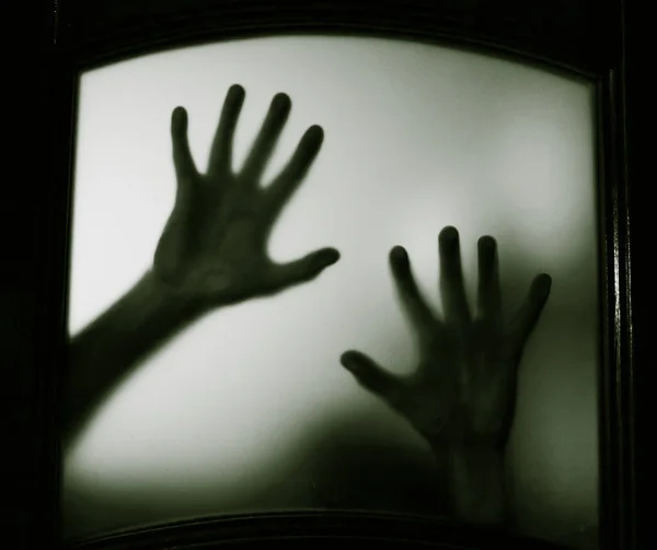 scary picture of hands behind glass, horror ghost behind door, Halloween  concept