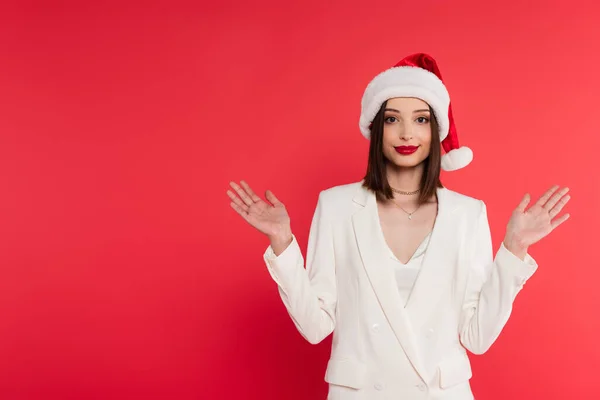 Stylish Woman Red Lips Santa Hat Pointing Hands Isolated Red — Stock Photo, Image