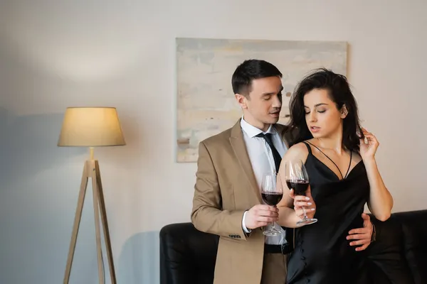 Young Sexy Couple Holding Glasses Red Wine Living Room — Stock Photo, Image