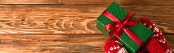 Cropped View Person Red Mittens Holding Wrapped Gift Box Wooden — Stock Photo, Image