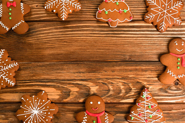 flat lay with gingerbread cookies on wooden surface