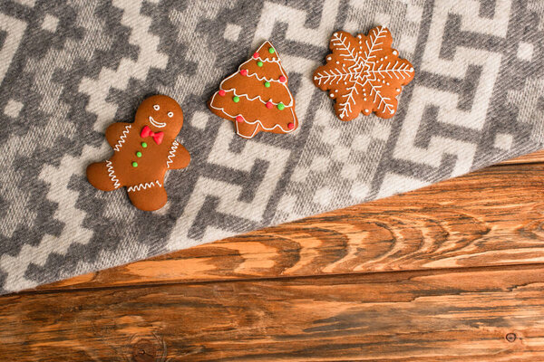 top view of gingerbread cookies on grey blanket with ornament 
