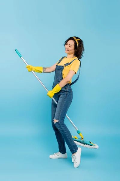 Happy Housewife Yellow Rubber Gloves Denim Overalls Posing Mop Blue — Stock Photo, Image