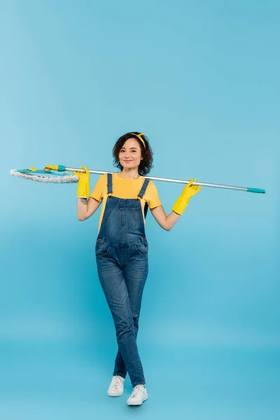 Happy Housewife Yellow Rubber Gloves Denim Overalls Posing Mop Blue — Stock Photo, Image
