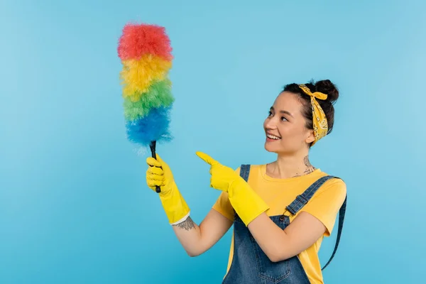 Smiling Housewife Yellow Rubber Gloves Pointing Colorful Dust Brush Isolated — Stock Photo, Image