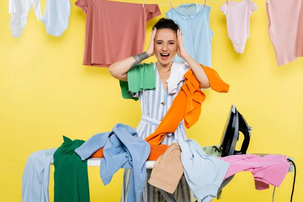 Shocked Housewife Touching Head While Screaming Laundry Ironing Board Yellow — Stock Photo, Image