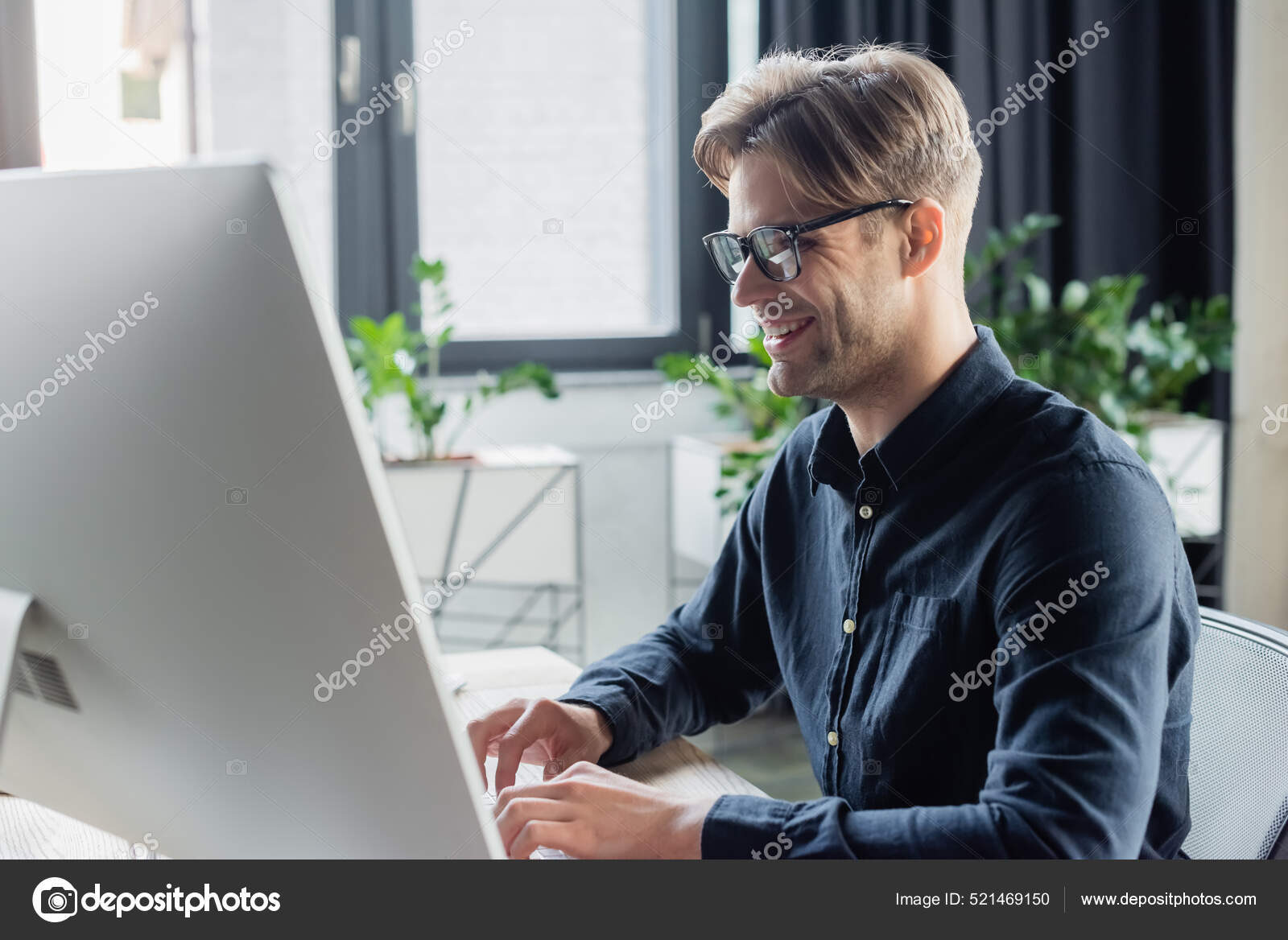 Smiling Developer Eyeglasses Using Computer Keyboard Monitor Office