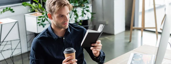 Young Programmer Looking Notebook While Holding Coffee Computer Office Banner — Stock Photo, Image