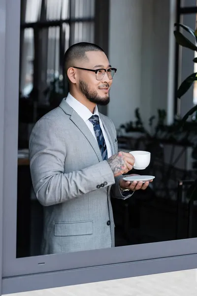 Smiling Asian Businessman Cup Coffee Standing Window Office — Stock Photo, Image