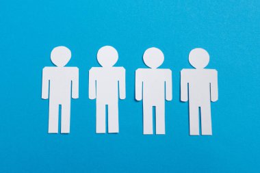 top view of white paper cut people isolated on blue, team concept  clipart