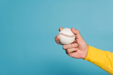 cropped view of sportsman holding baseball on blue clipart