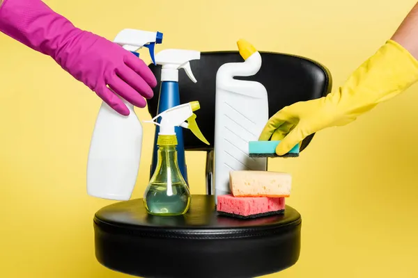Cropped View Cleaners Reaching Bottle Detergent Sponge Black Chair Isolated — Stock Photo, Image