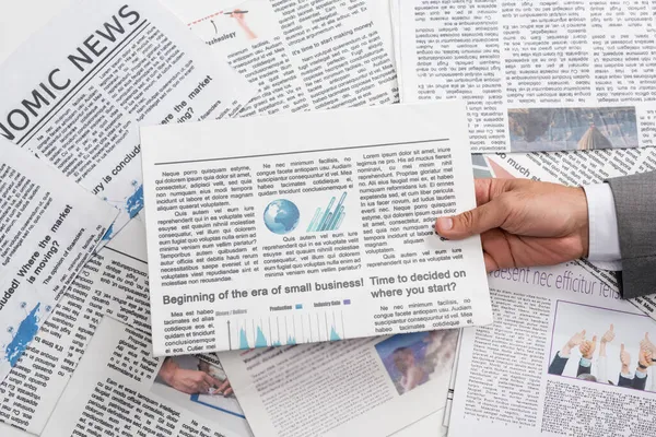 top view of businessman holding newspaper